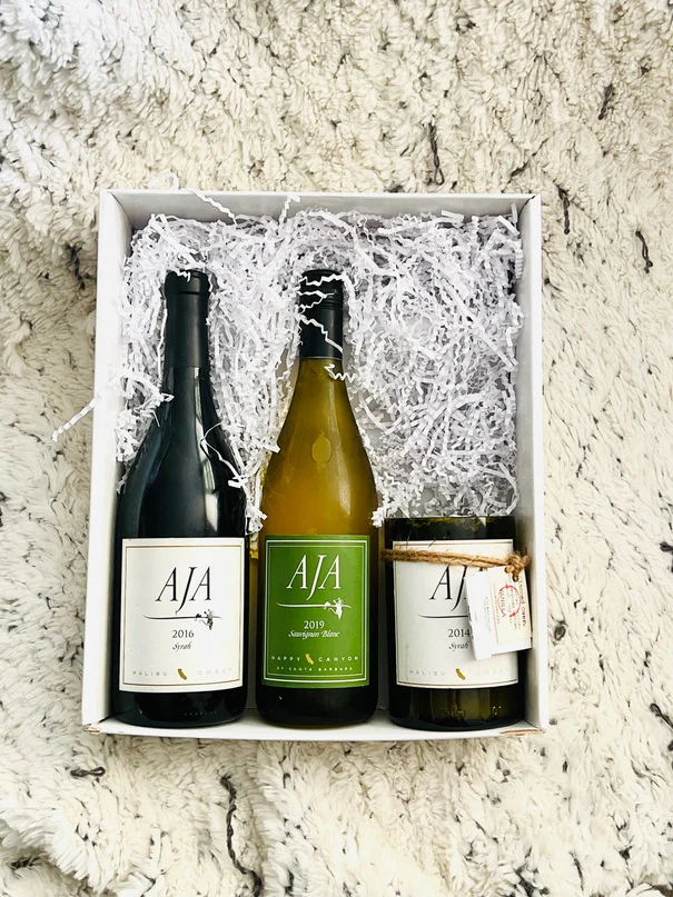 Three AJA wines in a white gift box with crinkle paper